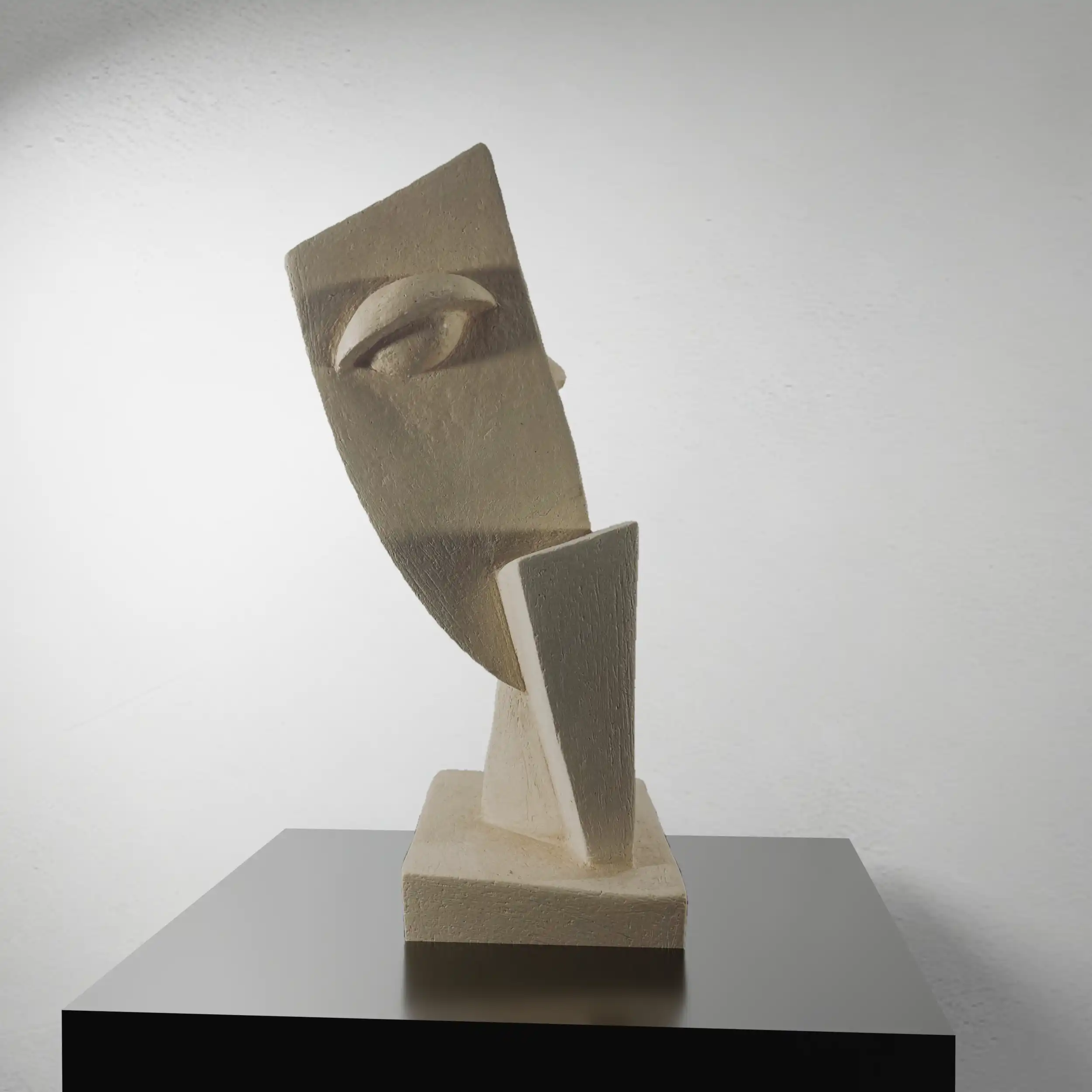 Vertical ceramic sculpture with faceted geometric planes, hollow opening, diagonal lean on rectangular base